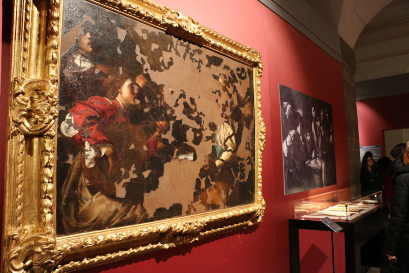 Two paintings, one heavily damaged and the other completely destroyed, on exhibit in the first section.