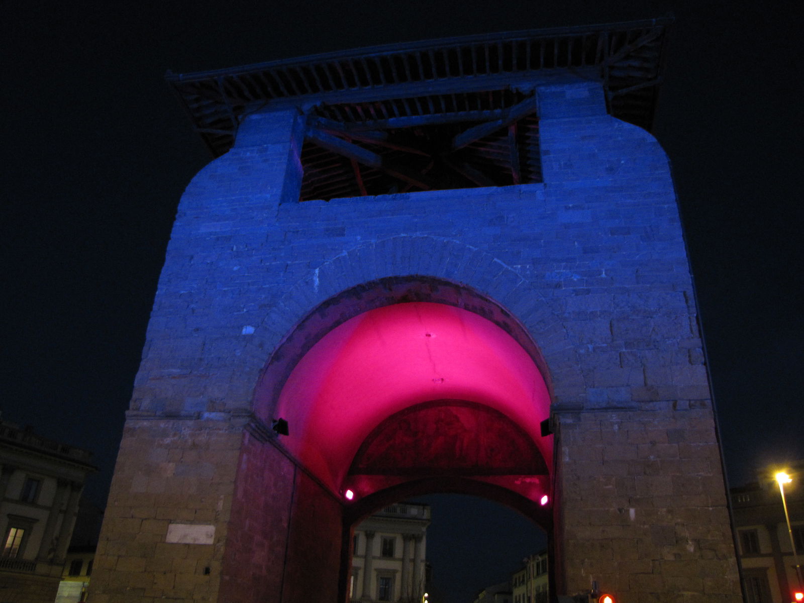 Walking under the arches of Porta alla Croce in Piazza Beccaria